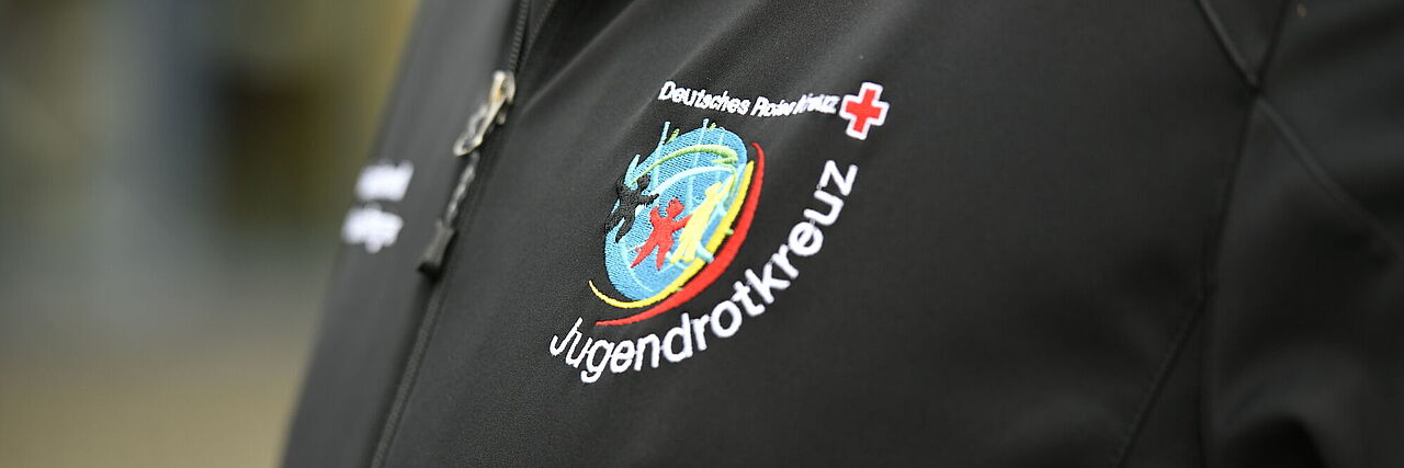 schwarzes Poloshirt mit Jugendrotkreuz-Aufdruck